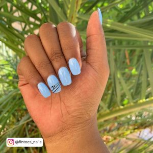 Light Blue Gel Nails With Design On Ring Finger