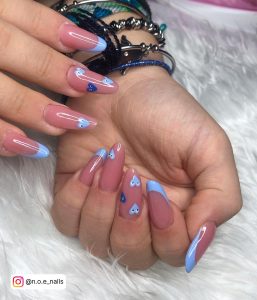 Light Blue Nails With Hearts In French Tip Design