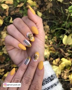 Matte Black And Yellow Nails With Leaves