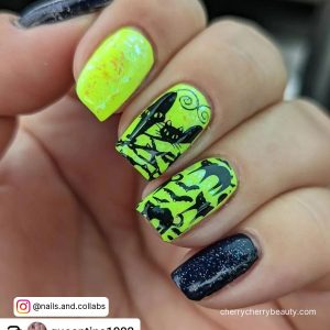 Neon Green And Black Acrylic Nails With A Different Design On Each Finger