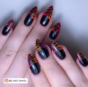 Neon Orange And Black Nails In Stiletto Shape