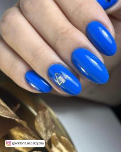 Ocean Blue Nails With Design On Ring Finger
