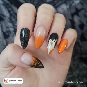 Ombre Orange And Black Nails In Stiletto Shape With Glitter