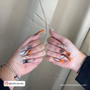 Orange Black And White Nails With Webs And Stitches