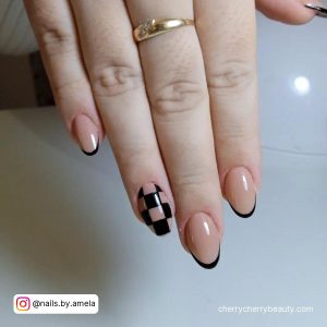 Short Black Almond Nails With Check Pattern On Two Fingers