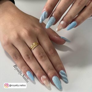 Sky Blue Acrylic Nails With Swirls, Flowers, And Glitter