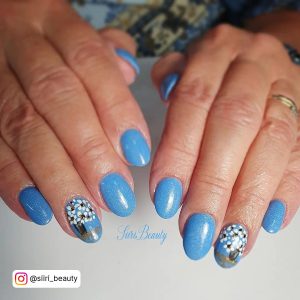 Sky Blue Almond Nails With Design On Ring Finger