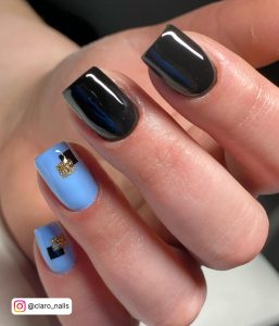 Sky Blue And Black Nail Art With Design On Two Fingers