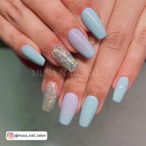 Sky Blue Nails With Glitter On Ring Finger