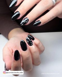White And Black Almond Nails With Design On Ring Finger