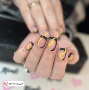 Yellow And Black Marble Nails In French Tip Design