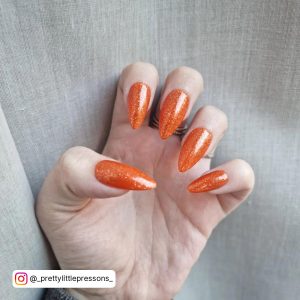 Black With Orange Glitter Nails