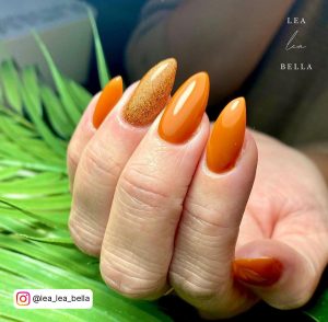 Orange Nails With Black Glitter